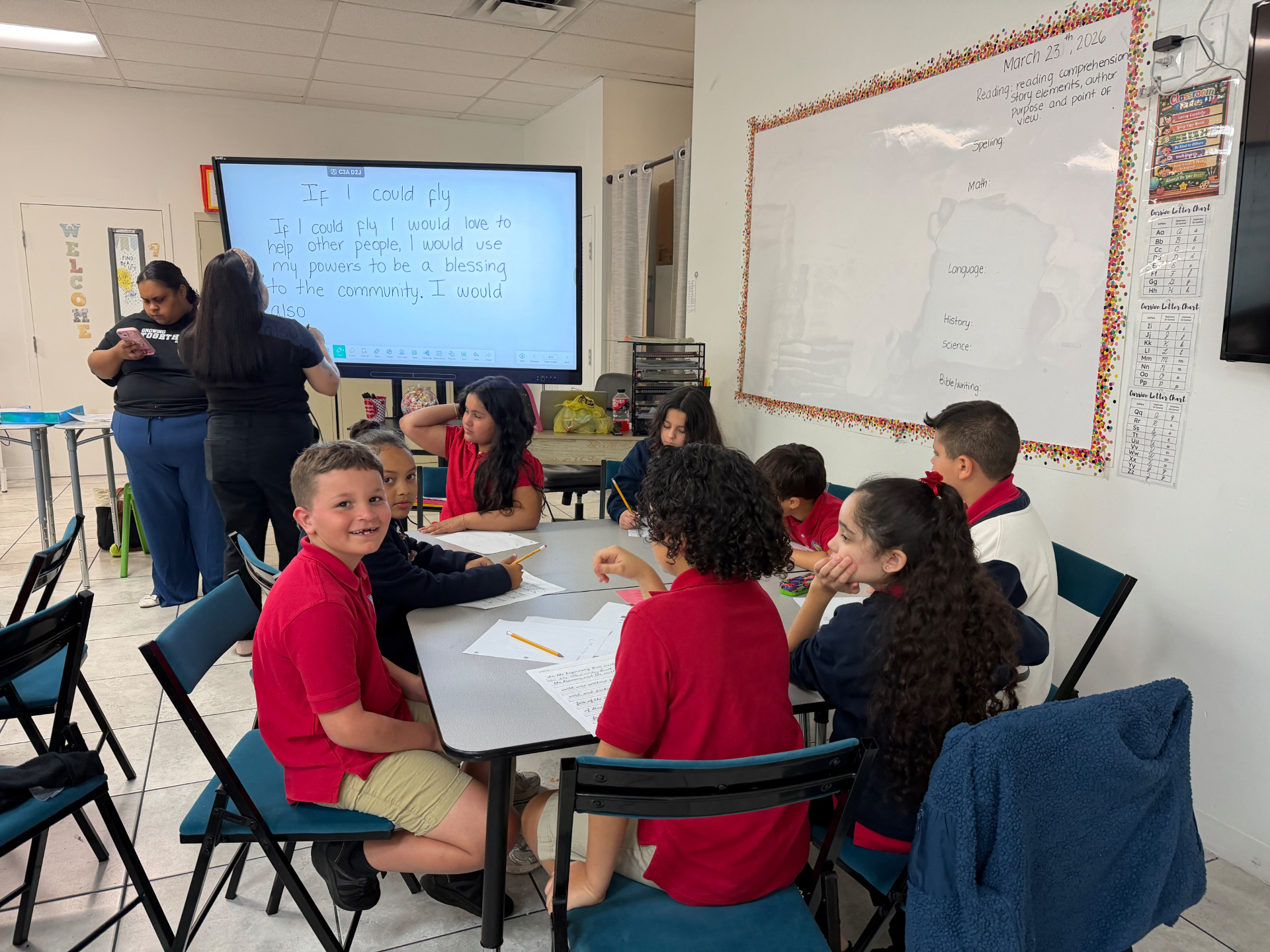 Growing Together Academy classroom with students engaged in reading and writing activities