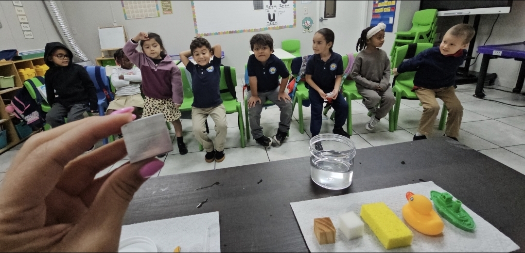 Students at Growing Together Academy participating in a hands-on science experiment about sinking and floating